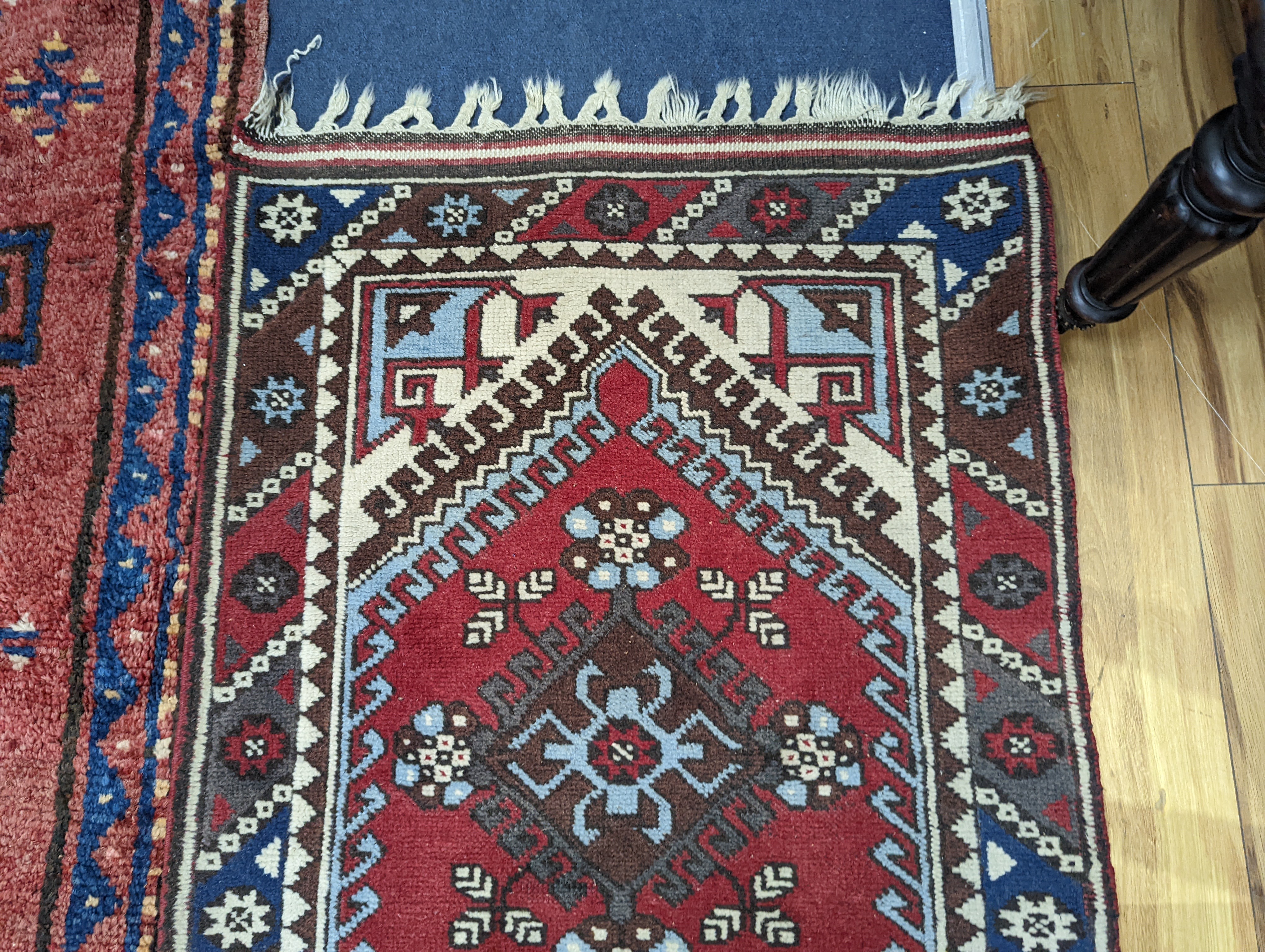 A Caucasian design red ground runner, 300 x 78cm